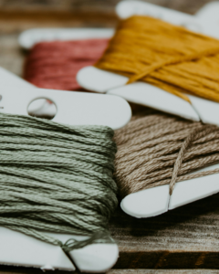 A collection of different colored threads.
